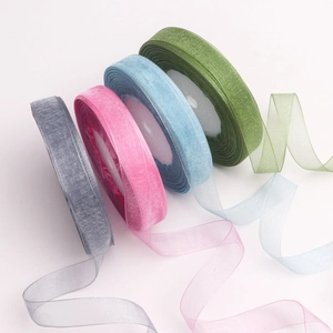 Detail view of 1.5cm transparent organza ribbons in grey, pink, blue and green rolls