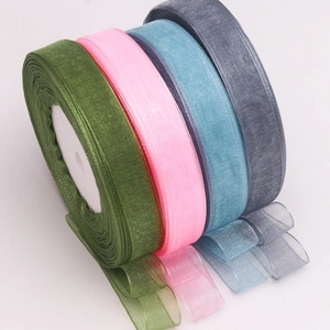 Close-up of translucent organza ribbons in green, pink, blue and grey for DIY crafts