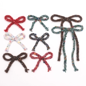 Close-up of assorted colorful handmade knitted ribbon bows for DIY hair accessories