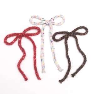 Three knitted Christmas yarn bows in red, multi-color, and brown for DIY crafts