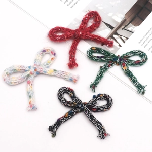 Macro view of colorful knitted wool bow accessories for DIY hair clips and decorations