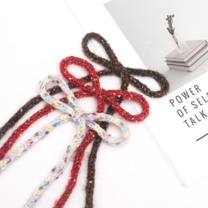Handmade knitted wool bow ribbons in white, red, and brown for DIY hair accessories and gifts