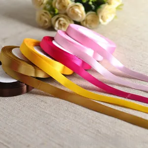 Close-up of 10mm satin polyester ribbons in multiple colors for gift wrapping