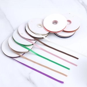 Various colors of 1cm polyester satin ribbon rolls for gift wrapping and DIY crafts