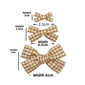 Detailed size chart showing three sizes of plaid fabric bows with height and width