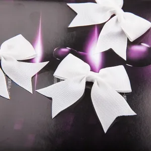 Macro shot of white grosgrain ribbon bow texture and fabric details for DIY craft accessories