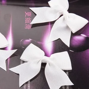 White grosgrain ribbon bows with swallowtail ends for gift boxes and clothing accessories