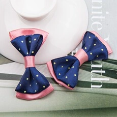 Detail of pink satin and navy polka dot double-layer bow ribbon for gift wrapping