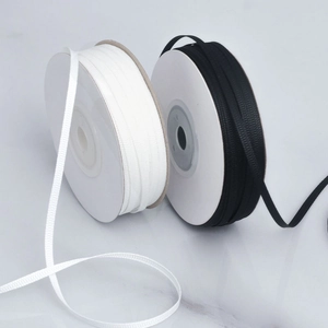 Detail of 0.3cm ribbed grosgrain ribbon rolls in black and white for gift wrapping