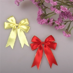 Detail of red and yellow satin ribbons with gold metallic edges for gift wrapping