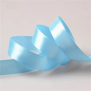 Macro detail of 2cm light blue satin ribbon showing smooth texture and woven edges
