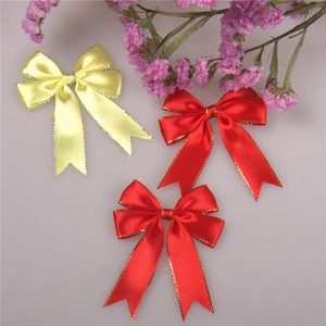 Close-up of satin ribbon bows with metallic edges for gift boxes and flower packaging