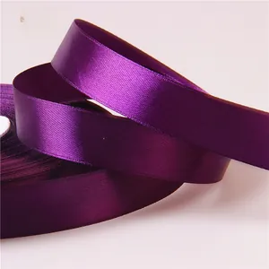 Detailed macro view of 2cm dark purple satin ribbon with silky texture for gift wrapping