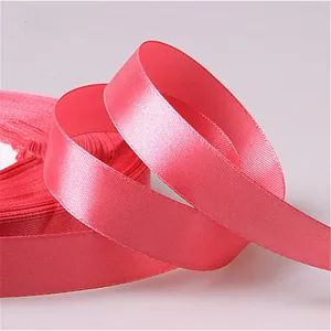 Detailed view of pink satin ribbon with smooth texture and glossy silk finish for gift wrapping
