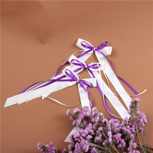 Detail of white and purple satin bows with smooth ribbon texture for wedding decor