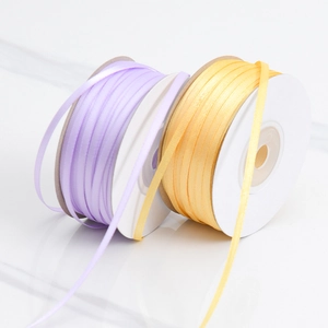 Rolls of 3mm double-sided polyester satin ribbon in lavender and gold for DIY crafts