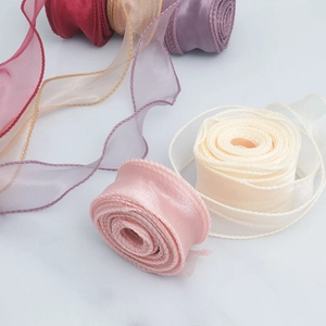Rolls of 4cm overlocked chiffon ribbons in soft pink, beige, and purple for gift wrapping