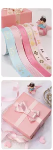 Close-up of gold-stamped satin ribbons with Princess crown patterns in macaron colors