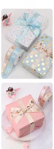 Detail of pink and blue satin ribbons with gold foil Princess and clover patterns