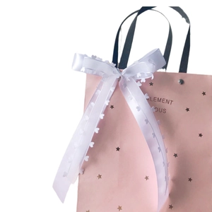 Pink heart-themed gift bag with gold stars and a white satin bow lace ribbon