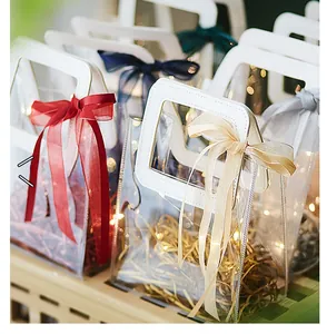 Detailed view of PVC gift bags with satin bows, leather handles and warm LED lighting