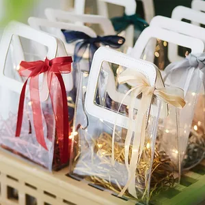 Transparent PVC gift bags with leather handles and colorful satin ribbon bows