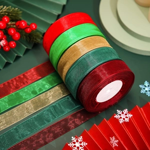Detailed view of five multi-color organza ribbon rolls for Christmas gift wrapping