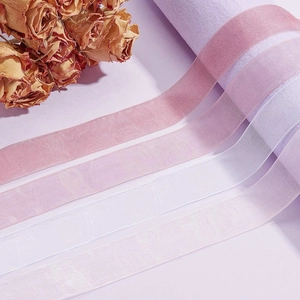 Macro detail of transparent organza ribbons in gradient pink and purple tones