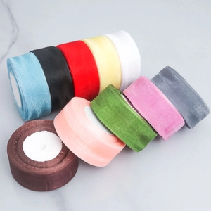 Colorful 2.5cm organza ribbons roll set for gift wrapping and baking on marble background