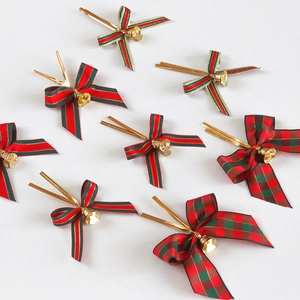 Christmas bow decorations with bells in red and green stripes and plaid patterns