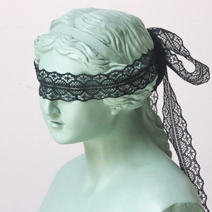 Detail of 3cm black floral lace ribbon tied as a decorative bow on a classical bust