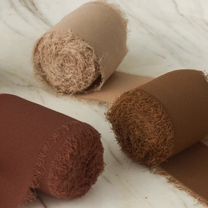 Three rolls of frayed edge chiffon ribbons in brick red, light tan, and dark coffee brown