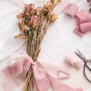 Close-up of pink frayed edge chiffon ribbon with a soft translucent texture for weddings