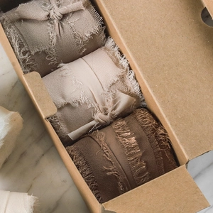 Set of three frayed edge chiffon ribbons in earth tones packed in a kraft gift box