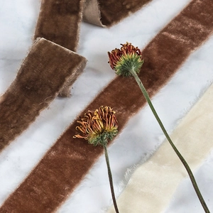 Macro view of frayed edge velvet ribbons in earth tones for wedding gift wrapping decor