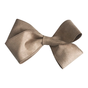 Detailed close-up of brown velvet ribbon bow with neat edge stitching for DIY crafts