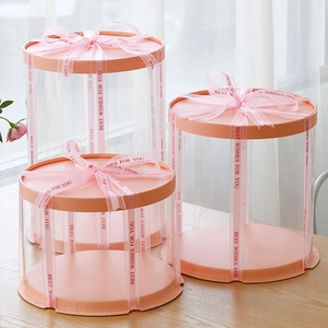 Three-piece set of transparent cylindrical cake boxes with pink lids and printed ribbons