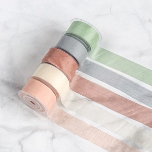 Detailed close-up of 4cm sheer chiffon ribbons with elegant pleats in soft pastel colors
