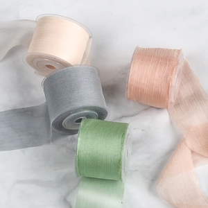 Detail view of 4cm sheer chiffon ribbons with raw edges in pastel colors for wedding decor
