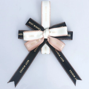 Detail of multi-layered bow with Best Wishes text and metallic gold edge ribbons