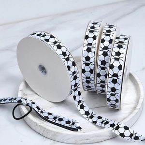 Detailed view of white polyester grosgrain ribbon with black and white soccer ball patterns