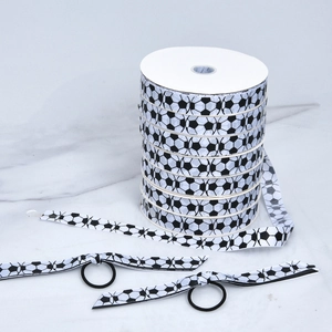 Detail of soccer print polyester grosgrain ribbon rolls and matching hair bows