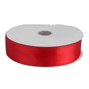 Vibrant red satin ribbon roll for wedding decorations and gift packaging on white spool