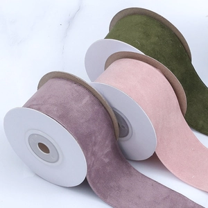 Three rolls of faux suede velvet ribbons in lavender, pink, and olive for DIY crafts
