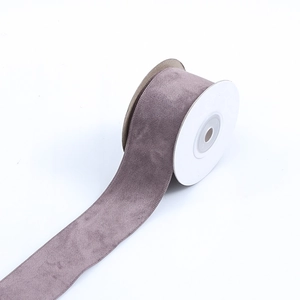 Detail of grey-purple velvet ribbon roll with sturdy white core for DIY craft making