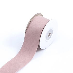 Detail view of dusty rose faux suede ribbon roll for DIY crafts and gift wrapping