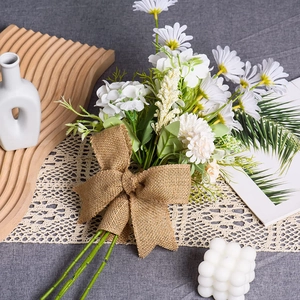 Detail of natural burlap fabric tied in a large bow on a rustic floral bouquet