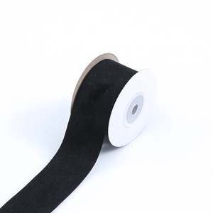 Close-up of black suede velvet ribbon roll for DIY crafts and garment accessories