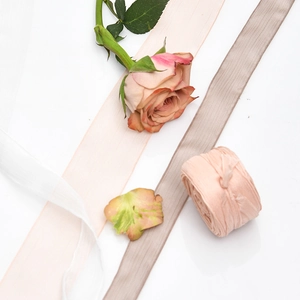 Elegant silk chiffon ribbons in soft tones for wedding invitations and floral bouquets