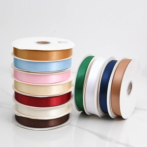 Close-up of colorful double-sided satin ribbon rolls for gift and flower packaging